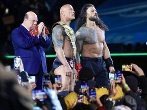 Paul Heyman, Dwayne (The Rock) Johnson and Undisputed WWE Universal champion Roman Reigns celebrate after defeating Cody Rhodes and WWE World Heavyweight champion Seth Rollins on Night One of WrestleMania 40 at Lincoln Financial Field in Philadelphia on April 7, 2024.