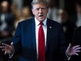 Former President Donald Trump speaks as he arrives at Manhattan criminal court with his legal team ahead of the start of jury selection in New York, Monday, April 15, 2024.