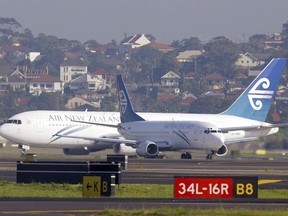 FILE - Two Air New Zealand passenger jets taxi past each other at Sydney Airport on July 13, 2003. A passenger has been fined for urinating in a cup during a delay on deplaning after landing at Sydney Airport. Officials said on Friday, April 5, 2024, in incident after a 3-hour Air New Zealand flight from Auckland occurred in December last year and a Sydney court fined the 53-year-old man 600 Australian dollars for offensive behavior in February.