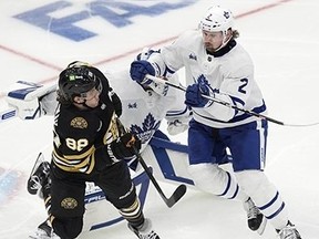 Toronto Maple Leafs' Simon Benoit (2) defends against Boston Bruins' David Pastrnak (88) in front of goalie Ilya Samsonov during the second period in Game 1 of an NHL hockey Stanley Cup first-round playoff series Saturday, April 20, 2024, in Boston.