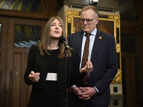 NDP MPs Laurel Collins and Peter Julian speak in the Foyer of the House of Commons before Question Period, on Parliament Hill in Ottawa, Wednesday, April 10, 2024.