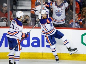 Edmonton Oilers forward Connor Brown (28) celebrates his goal with teammate forward Mattias Janmark (13) during second period NHL hockey action against the Calgary Flames in Calgary, Alta., Saturday, April 6, 2024.