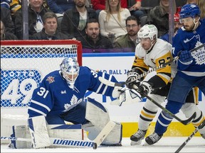 Sidney Crosby, battling Leafs defenceman Timothy Liljegren and goalie Martin Jones during a game in Toronto earlier this season, are back in town on Monday riding a late-season hot streak.