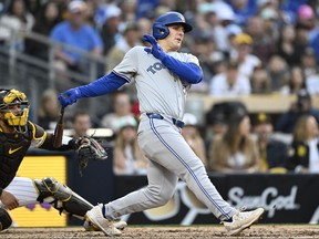 Daulton Varsho of the Toronto Blue Jays hits a double during the third inning of a baseball game against the San Diego Padres on Saturday night.