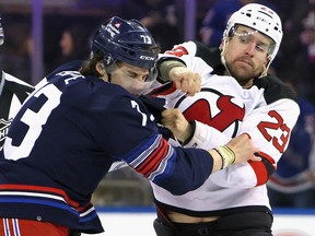 Kurtis MacDermid of the New Jersey Devils fights with Matt Rempe of the New York Rangers at Madison Square Garden on April 3, 2024 in New York.