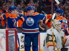 Ryan McLeod (71), Cody Ceci (5), Cory Perry and Dylan Holloway (55) of the Edmonton Oilers, celebrate a first period goal against the Las Vegas Golden Knights at Rogers Place in Edmonton on April 10, 2024.