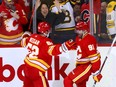 Calgary Flames forward Nazem Kadri celebrates with MacKenzie Weegar after scoring an overtime winner against the Boston Bruins at he Scotiabank Saddledome in Calgary on Feb. 22, 2024.