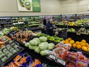 A customer walks through the produce section at a grocery store In Toronto on Friday, Feb. 2, 2024. A new report predicts that grocery inflation will fall below two per cent by the spring and stay roughly between one and two per cent for the rest of 2024.