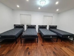 Room with four twin beds all in a row.