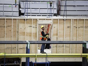 An employee works on a modular home component at NRB Modular Solutions in Calgary, Friday, April 5, 2024.