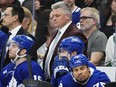Toronto Maple Leafs head coach Sheldon Keefe, top right, reacts on the bench with Calle Jarnkrok, left to right, Pontus Holmberg and Ryan Reaves during third period action against the Boston Bruins in Game 4 of an NHL hockey Stanley Cup first-round playoff series in Toronto on Saturday, April 27, 2024.