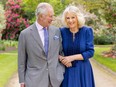 A handout photo issued by the Royal Household on April 26, 2024 shows King Charles III and Queen Camilla in the garden of Buckingham Palace in London, on April 10.
