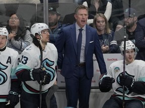 Seattle Kraken head coach Dave Hakstol reacts toward players during the third period of the team's NHL hockey game against the San Jose Sharks in San Jose, Calif., Monday, April 1, 2024.