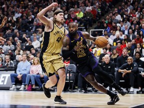 Lakers’ LeBron James drives against Raptors’ Kelly Olynyk at Scotiabank Arena on Tuesday night.