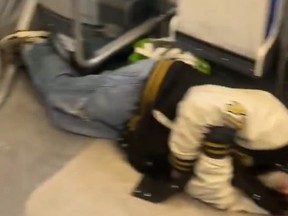 Screenshot of man sleeping on TTC streetcar floor.