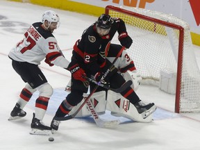 Senators centre Mark Kastelic tries to tip the puck past Devils goalie Jake Allen the second period of Saturday's game.