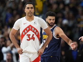 Raptors' Jontay Porter (left) and Denver Nuggets guard Jamal Murray in the second half of a game Monday, March 11, 2024, in Denver.
