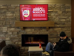 Signage for Tim Hortons' Roll Up the Rim contest is seen inside a Tim Hortons restaurant in Toronto, Friday, March 6, 2020.