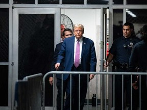 Former U.S. president Donald Trump steps outside the courtroom during a break at his trial for allegedly covering up hush money payments linked to extramarital affairs, at Manhattan Criminal Court in New York City on April 19, 2024.