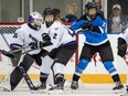 Toronto's Natalie Spooner battles for position with Minnesota's Lee Stecklein in front of goaltender Maddie Rooney during a PWHL game on May 1, 2024.