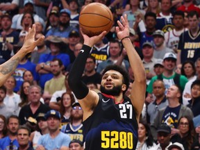 Jamal Murray of the Denver Nuggets shoots a three-pointer against the Minnesota Timberwolves.