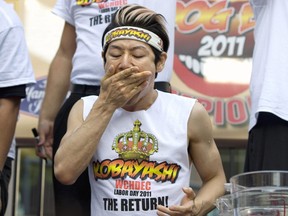 Competitive eating champion Takeru Kobayashi stuffs hot dogs in his mouth on his way to winning the Derby Deli & Dueling Piano Bar’s 3rd Annual “West Coast Hot Dog-Eating Championship” in 2011.