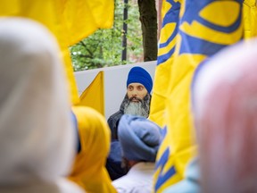 A portrait of Sikh activist Hardeep Singh Nijjar is seen as protesters gather outside the Consulate of India in Vancouver, B.C., Saturday, June 24, 2023.