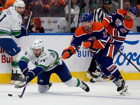 The Edmonton Oilers' Derek Ryan (10) battles the Vancouver Canucks' Pius Suter (24) during first period NHL playoff action at Rogers Place, in Edmonton Saturday May 18, 2024. Photo by David Bloom