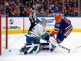 The Edmonton Oilers' Dylan Holloway (55) scores on Vancouver Canucks' goalie Arturs Silovs (31) during first period NHL playoff action at Rogers Place, in Edmonton Saturday May 18, 2024.