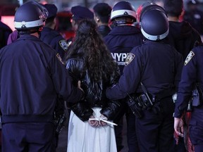 NYPD officers arrest students at Columbia University in New York City on April 30, 2024. New York police entered Columbia University's campus late April 30, 2024 and were in front of a building barricaded by pro-Palestinian student protesters, an AFP reporter saw. Dozens of people were around Hamilton Hall, on the Columbia campus in the middle of New York City, as police arrived and began pushing protesters outside, the reporter said. (Photo by CHARLY TRIBALLEAU / AFP)