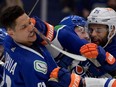 Canucks winger Dakota Joshua is hit in the face by the stick of Oilers defenceman Darnell Nurse on Friday. No penalty was called.