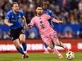Lionel Messi, right, of Inter Miami dribbles the ball against CF Montréal's Samuel Piette during the second half at Saputo Stadium on Saturday, May 11, 2024 in Montreal.