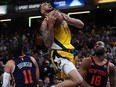Obi Toppin (1) of the Indiana Pacers shoots the ball over Jalen Brunson (11) of the New York Knicks and Alec Burks (18) of the New York Knicks in Game 4 of the Eastern Conference Second Round Playoffs at Gainbridge Fieldhouse on Sunday, May 12, 2024 in Indianapolis, Ind.