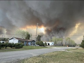 Several images have been shared online of a massive wildfire that began on Saturday and forced the complete evacuation of the town of Cranberry Portage in northwestern Manitoba. Facebook photo