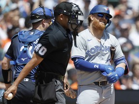 Justin Turner of the Blue Jays reacts after being called out on strikes by home plate umpire Roberto Ortiz at Comerica Park on May 25, 2024 in Detroit