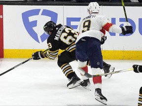 Florida Panthers' Sam Bennett (9) checks Boston Bruins' Brad Marchand (63) during the first period in Game 3 of their series.