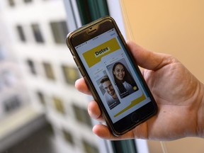 An AFP journalist holds his phone showing the dating application Bumble on February 26, 2020 in Washington, DC.