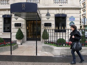 A woman walks in front of the ultra-luxury jewellery house Harry Winston on December 5, 2008, in Paris.