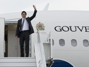 Prime Minister Justin Trudeau waves as he boards a government plane in Ottawa, Sunday, July 9, 2023. THE CANADIAN PRESS/Adrian Wyld