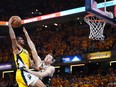 Obi Toppin of the Indiana Pacers goes up for a basket while defended by Pat Connaughton of the Milwaukee Bucksduring the first quarter of game six of the Eastern Conference First Round Playoffs at Gainbridge Fieldhouse on May 2, 2024 in Indianapolis, Ind.