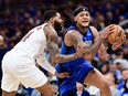 Paolo Banchero of the Orlando Magic drives to the basket against Marcus Morris Sr. of the Cleveland Cavaliers during the first quarter in Game Six of the Eastern Conference First Round Playoffs at Kia Center on May 3, 2024 in Orlando, Fla.