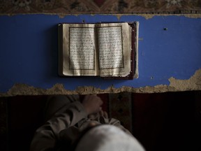 A student reads the Quran, Islam's holy book, at a madrasa in Kabul, Afghanistan, Tuesday, Sept. 28, 2021.