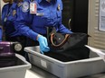 A Transportation Security Administration (TSA) worker screens luggage at LaGuardia Airport (LGA) on September 26, 2017.