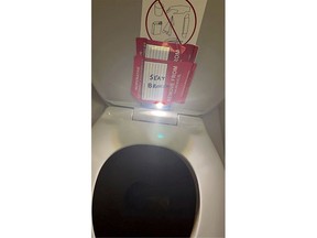In this photo provided by the law firm Lewis & Llewellyn LLP, an iPhone is taped to the back of a toilet seat on an American Airlines flight from Charlotte, N.C., to Boston, Sept. 2, 2023.