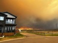 This handout image courtesy of Kosar shows smoke and flames from the fire in Fort McMurray, Alta., on May 14, 2024 as residents from the area of Abasand Heights evacuate the area.