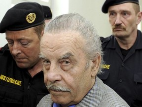 Josef Fritzl, center, is escorted to the fourth day of his trial in the provincial courthouse in St. Poelten, Austria, Thursday, March 19, 2009.