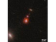 This image released by NASA shows the ZS7 galaxy system, revealing the ionized hydrogen emission in orange and the doubly ionized oxygen emission in dark red.