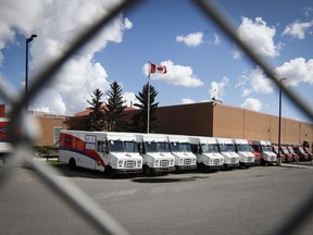 Delivery vehicles are seen at Canada Post's main plant in Calgary, Alta., Saturday, May 9, 2020.