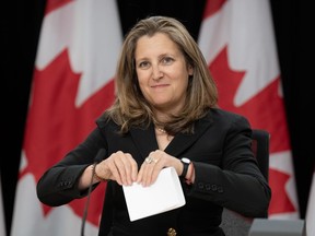 Deputy Prime Minister and Minister of Finance Chrystia Freeland folds a piece of paper after delivering her opening remarks at a news conference, Tuesday, May 21, 2024 in Ottawa.