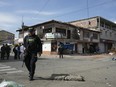 Police patrol the area after a motorcycle bomb exploded at a hotel in which some police officers would be staying in Jamundi, Colombia, Monday, May 20, 2024. According to authorities, two police officers were injured.